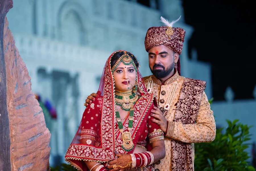Couple standing together outside a lit venue at night