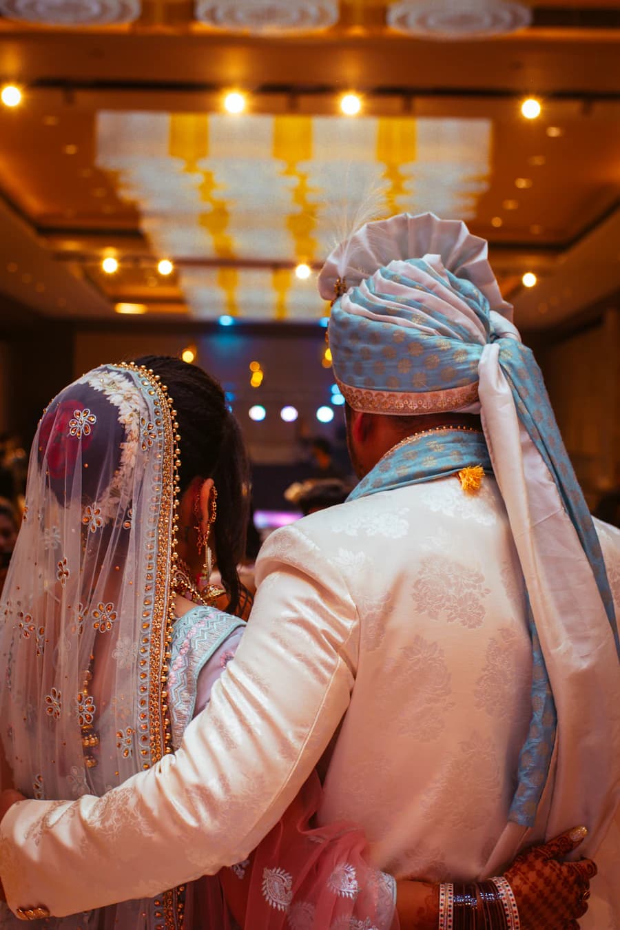 Couple seen from behind walking into a reception